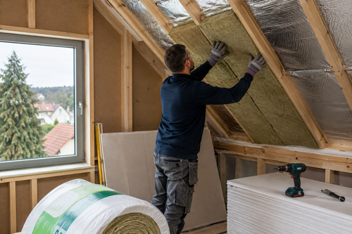 Vakman plaatst dakisolatie tijdens duurzame woningrenovatie in Limburg